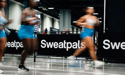 Athletes training indoors at Sweatpals fitness facility with motion blur effect