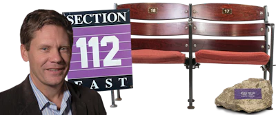 Professional man with stadium Section 112 sign and commemorative nameplate stone